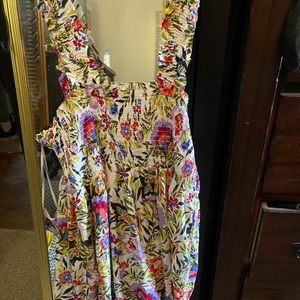 White/ floral knee length dress. Never worn. Shoulder straps are really elastic